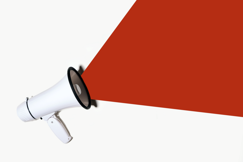 A red speech bubble emanates from a megaphone.